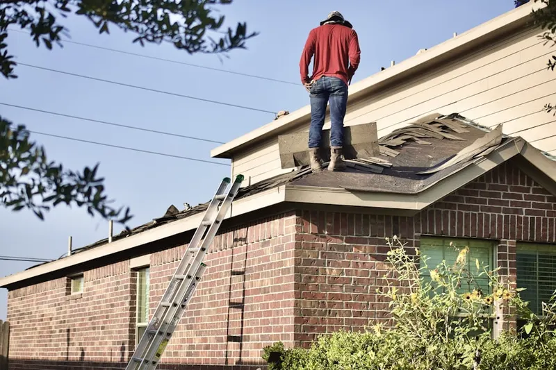 Professional roofer working on a residential roof in Allens